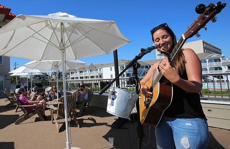 Harry's voted best in south jersey- woman playing guitar